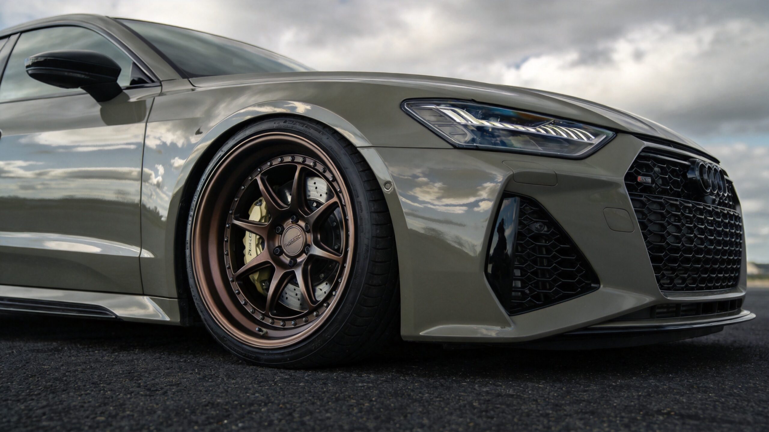 Bronze 6-spoke wheels + performance brakes + drilled rotors on a grey sports sedan — the JDM look that makes car guys stop and stare. This is what sells at retail.