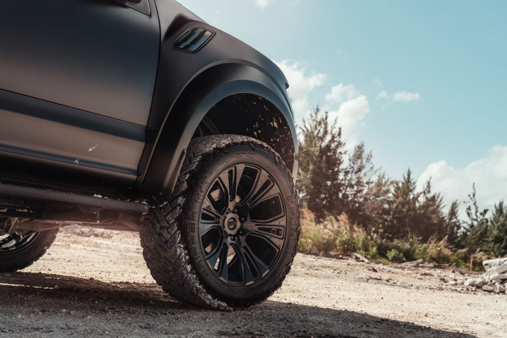 What it looks like when the rubber meets the dirt — aggressive stance, all-terrain tires, wheels that can actually handle the load.